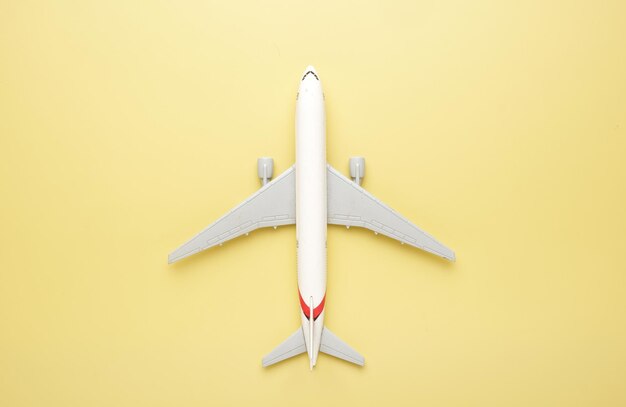 A picture of toy airplane on yellow background