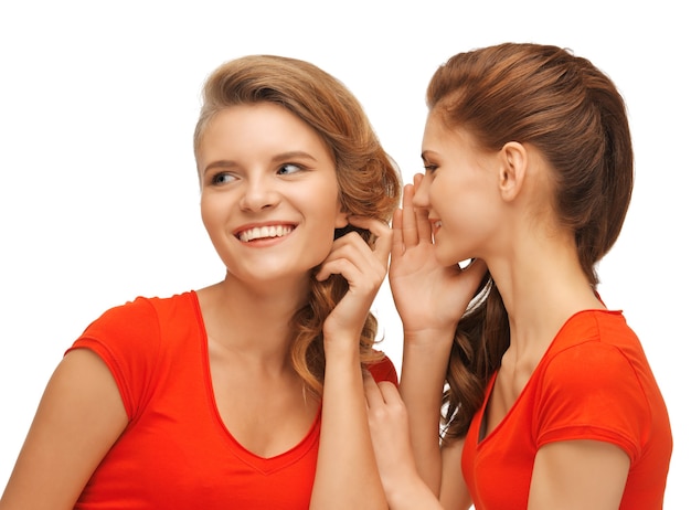 picture of two talking teenage girls in red t-shirts