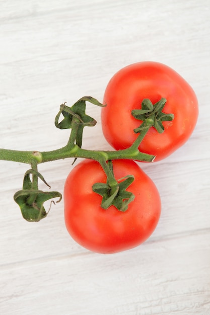 Picture of vine tomatoes on a white wooden background