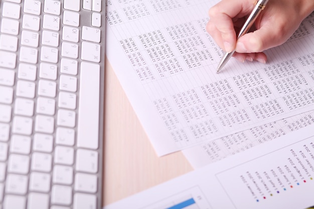 picture of woman hand writing on paper with numbers 