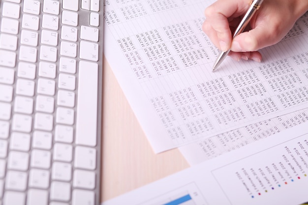 Picture of woman hand writing on paper with numbers 