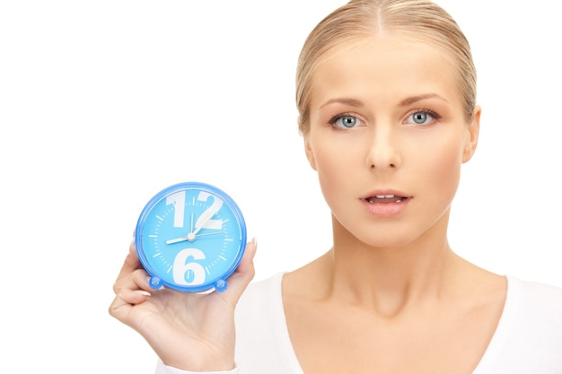 picture of woman holding alarm clock over white