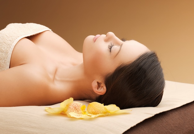 picture of woman in spa salon lying on the massage desk