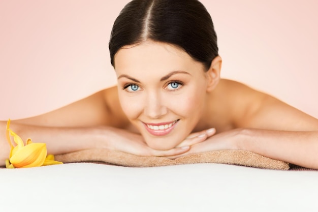 picture of woman in spa salon lying on the massage desk