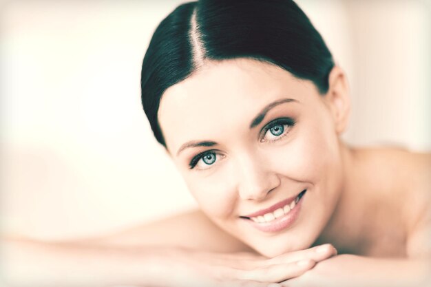 picture of woman in spa salon lying on the massage desk