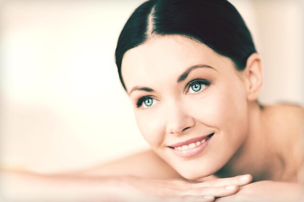 picture of woman in spa salon lying on the massage desk