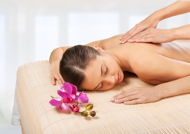 picture of woman in spa salon lying on the massage desk