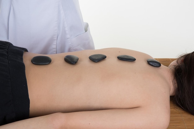 Picture of woman in spa salon with hot stones