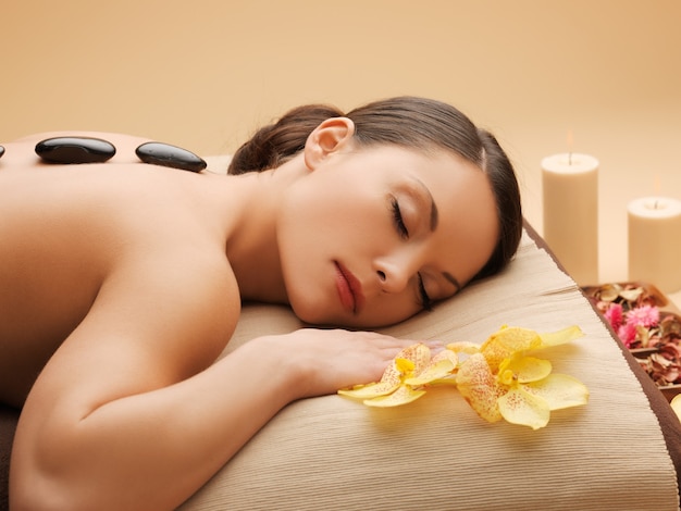 picture of woman in spa salon with hot stones