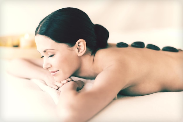 picture of woman in spa salon with hot stones