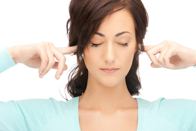 picture of woman with fingers in ears