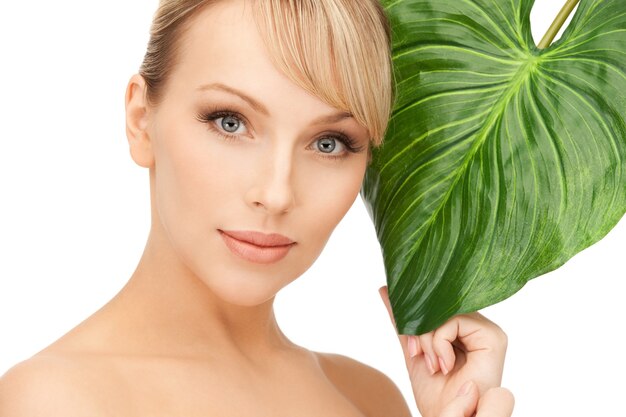 picture of woman with green leaf over white