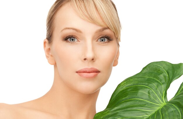 picture of woman with green leaf over white