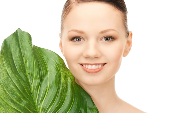 picture of woman with green leaf over white