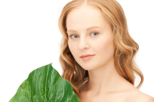 picture of woman with green leaf over white