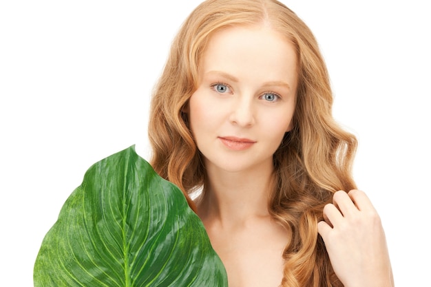 picture of woman with green leaf over white