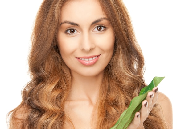 picture of woman with green leaf over white