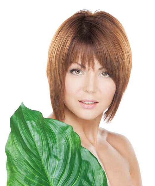 picture of woman with green leaf over white.