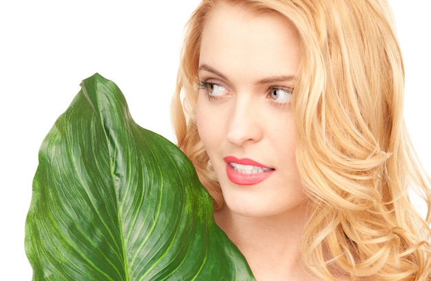 picture of woman with green leaf over white