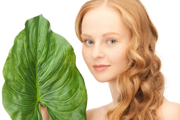 picture of woman with green leaf over white