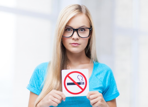 Photo picture of woman with smoking restriction sign