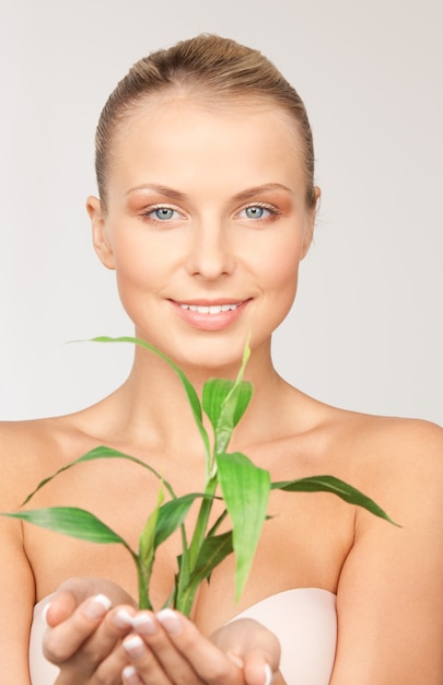 picture of woman with sprout over grey