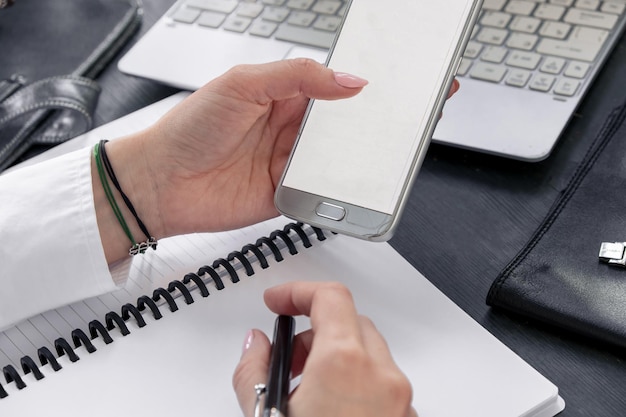 Picture of women hand whit pen and daily planner