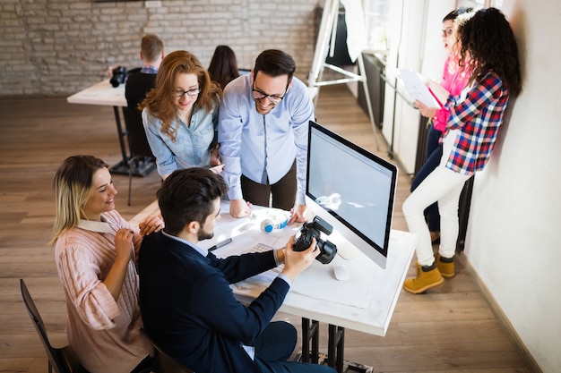 Picture of young attractive architects discussing in office