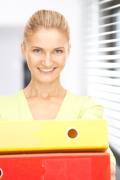 picture of a young attractive businesswoman with folders