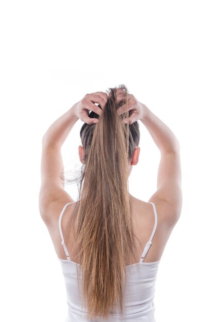 picture of a young beautiful woman fixing her hair