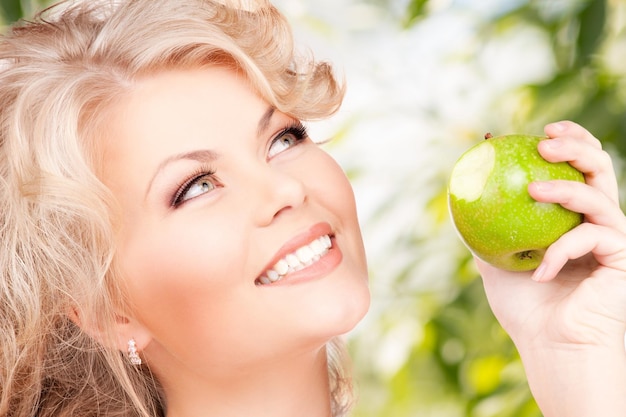 picture of young beautiful woman with green apple