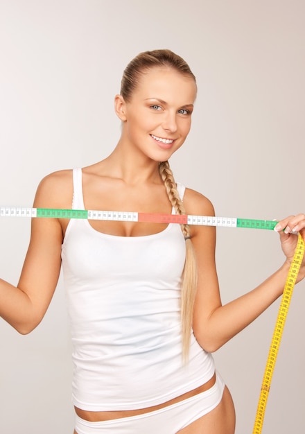 Photo picture of young beautiful woman with measure tape