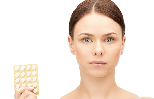 picture of young beautiful woman with pills