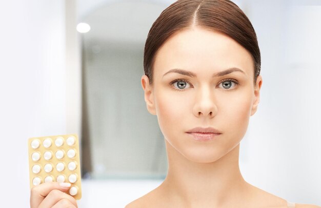 picture of young beautiful woman with pills