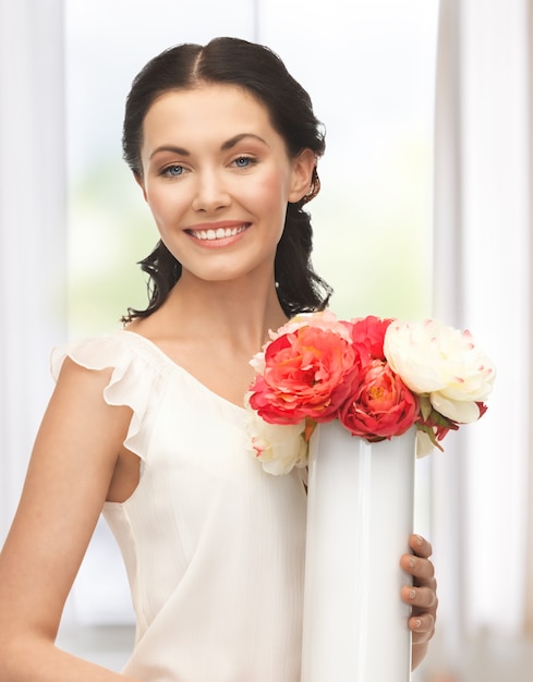 picture of young and beautiful woman with vase of flowers