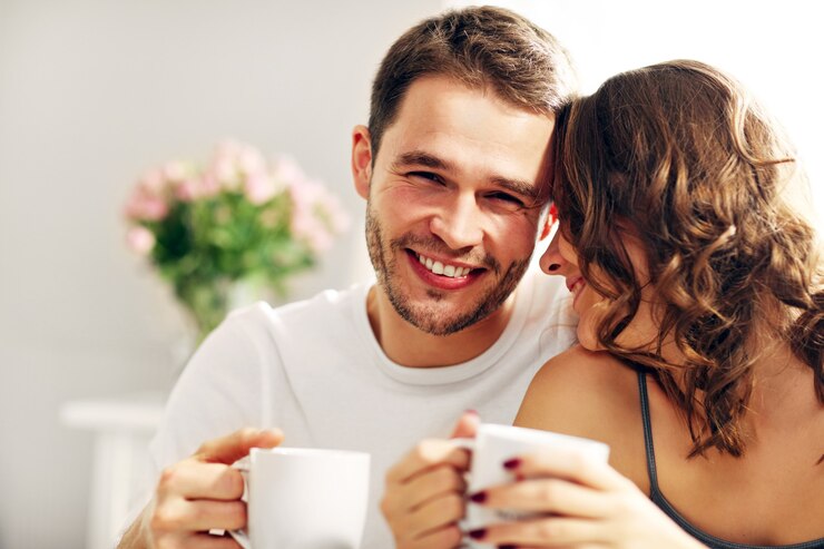 Photo picture of young couple drinking coffee in bed