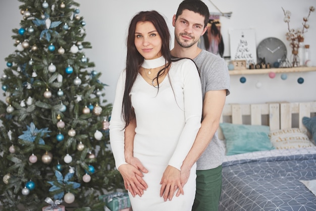 Picture of young couple hugging in Christmas time