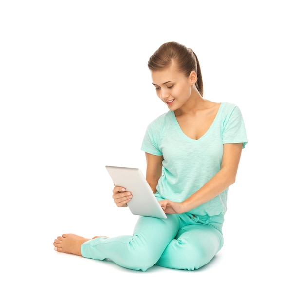 picture of young girl sitting on the floor with tablet pc