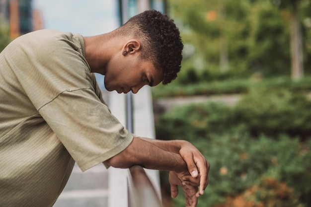 Picture of a young man in a thsirt standing outside