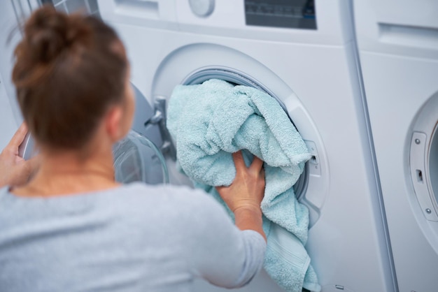 Picture of young woman making laundry work