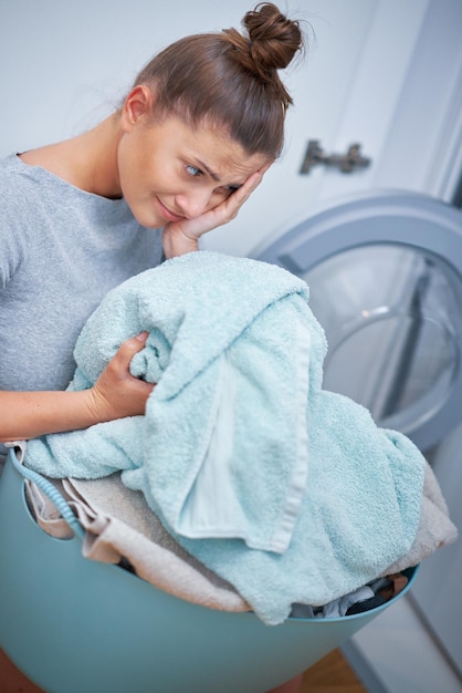 Picture of young woman making laundry work