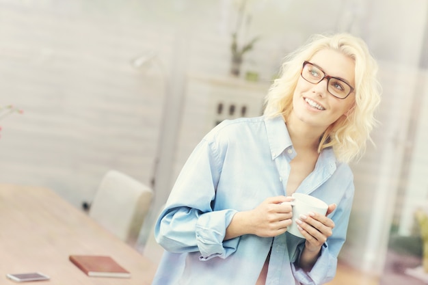 A picture of a young woman relaxing at home in the morning