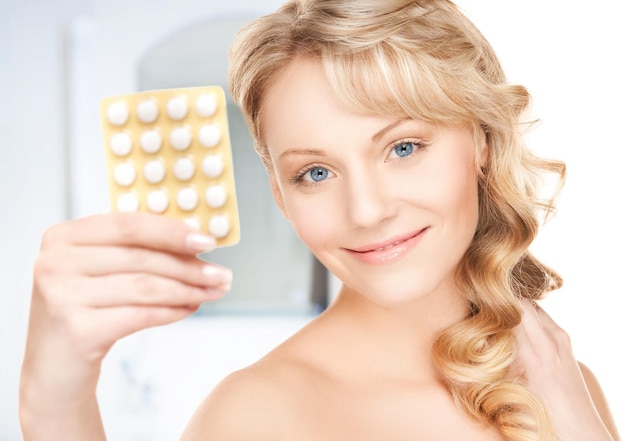 picture of young woman with pills at home