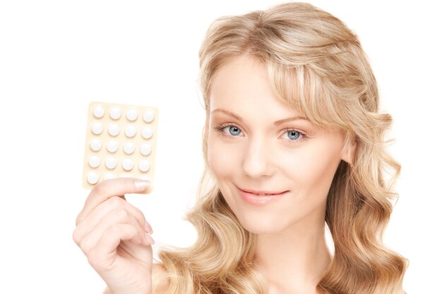 picture of young woman with pills over white