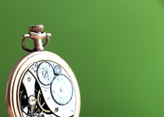 pictureof a Vintage pocket watch on green background