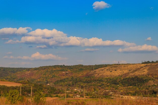 Picturesque autumn scenery with blue sky and colorful autumn trees on mountain hills