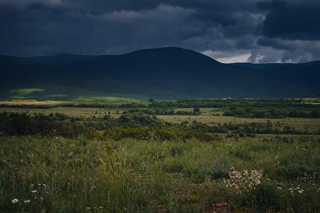 Picturesque green valley among the mountains before a storm