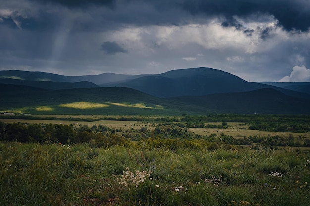 Picturesque green valley among the mountains before a storm