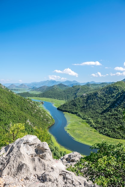 The picturesque meandering river flows among green mountains