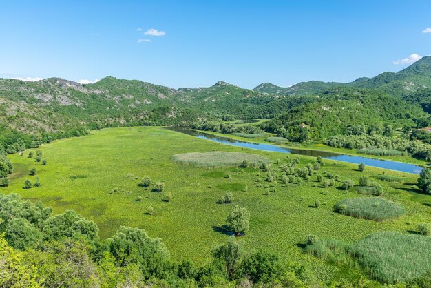 The picturesque meandering river flows among green mountains